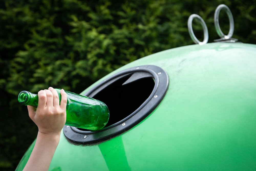 Child's,Hand,Throws,The,Glass,Bottle,In,A,Green,Container
